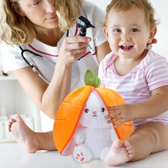 Bébé avec peluche lapin carotte